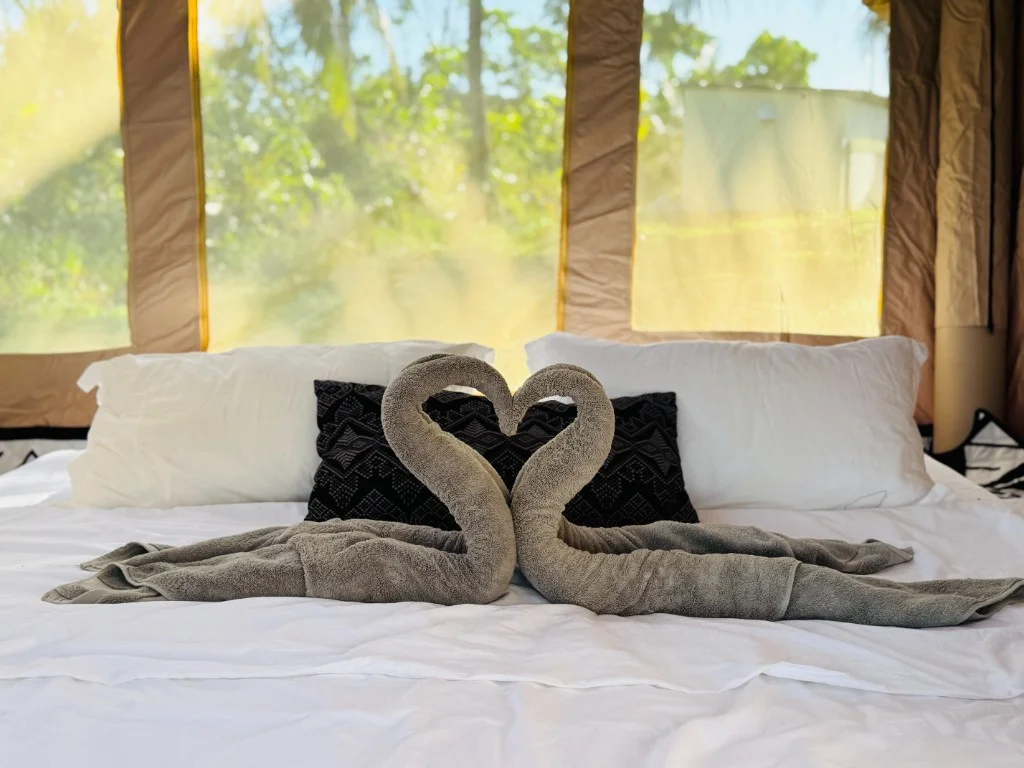 Eagle Bay Retreat tent bed with swan towels